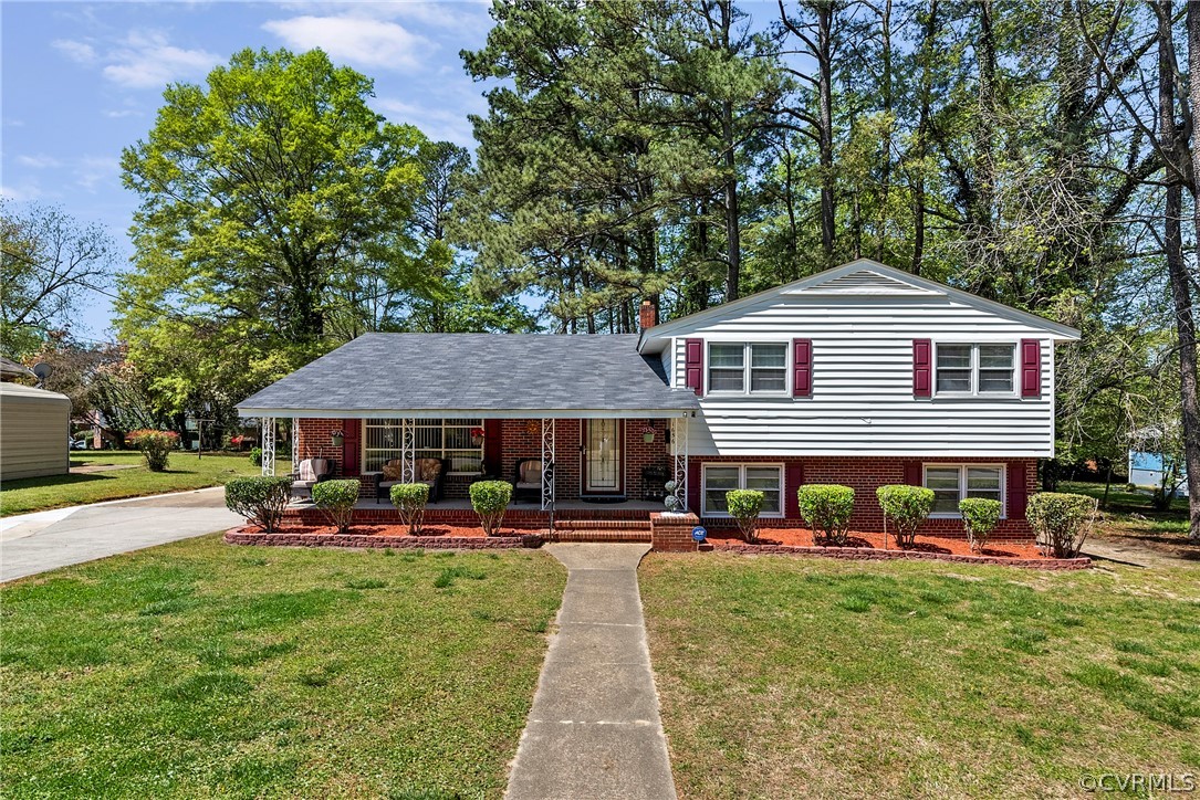 a front view of a house with a yard fire pit and outdoor seating