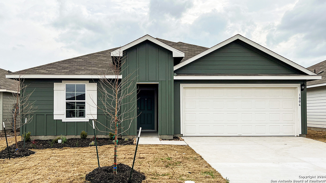 a front view of a house with parking space