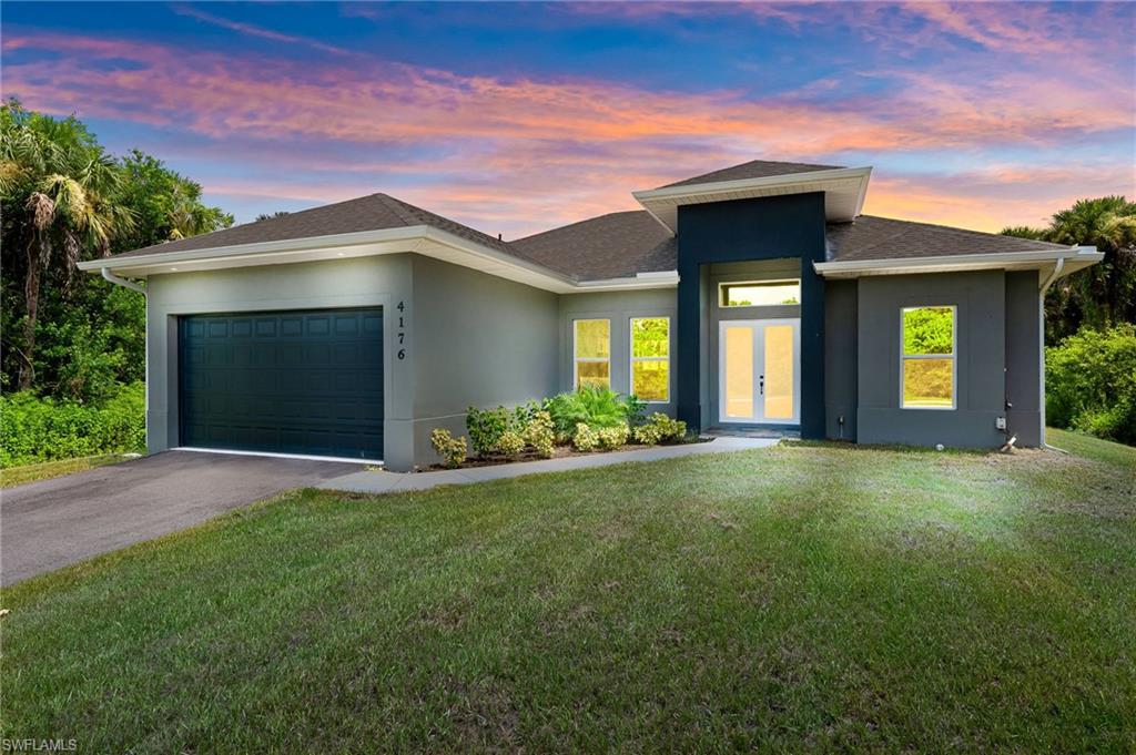 a front view of a house with a yard and garage