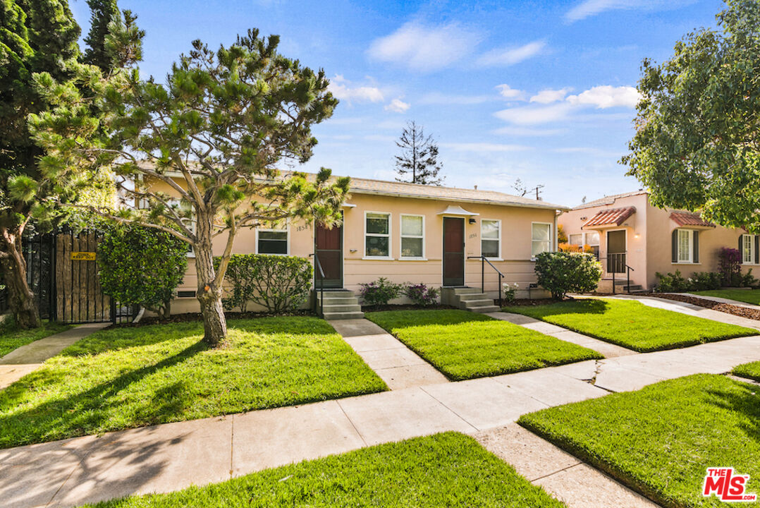 a view of a house with yard and tree s