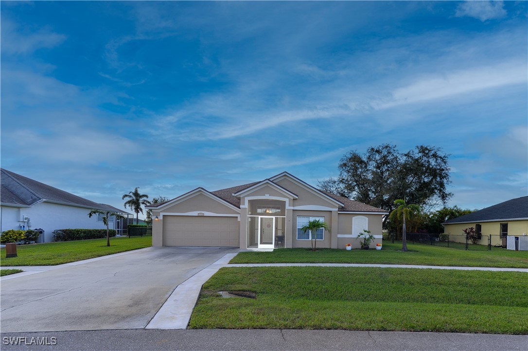 a front view of house with yard and green space