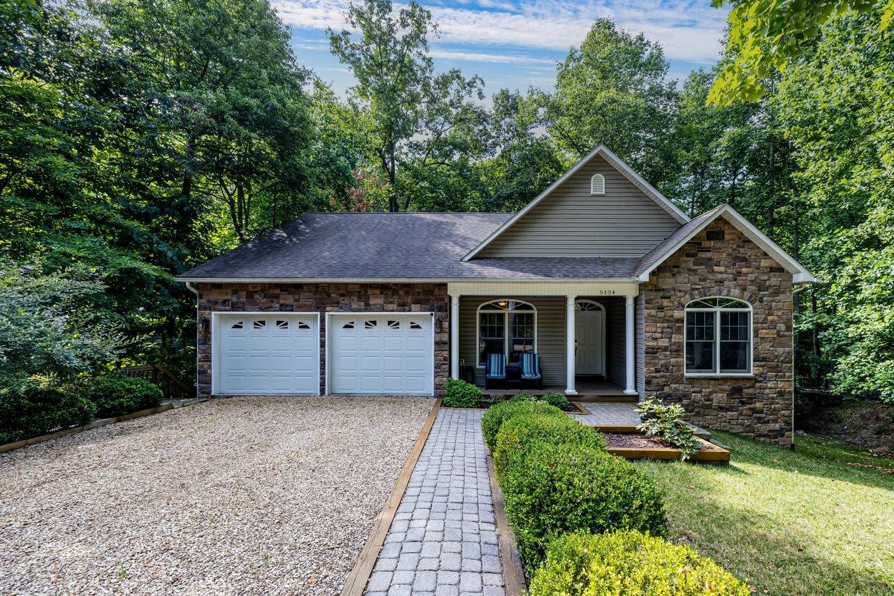 a front view of house with yard and green space