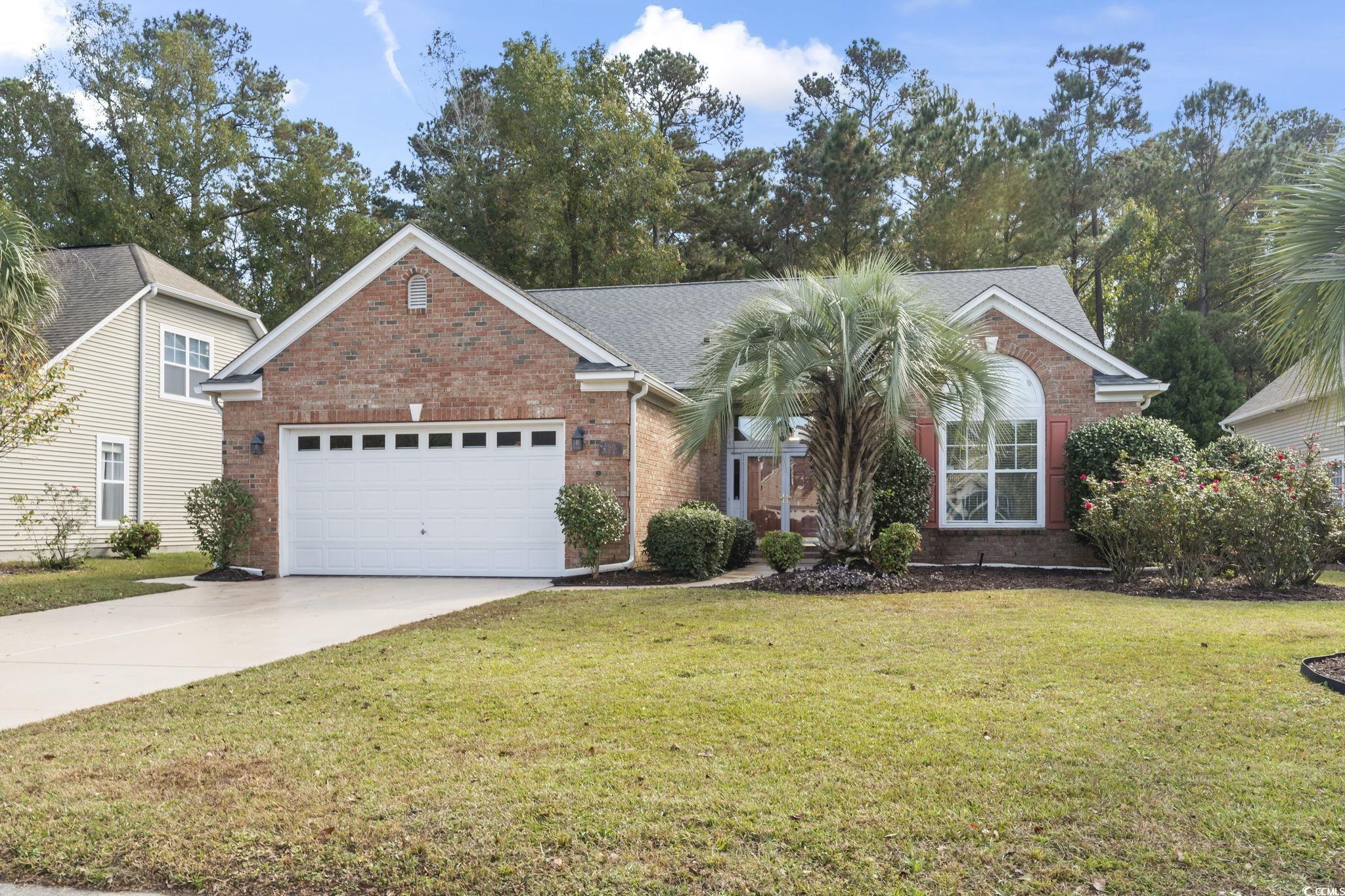 View of front of property featuring a garage and a