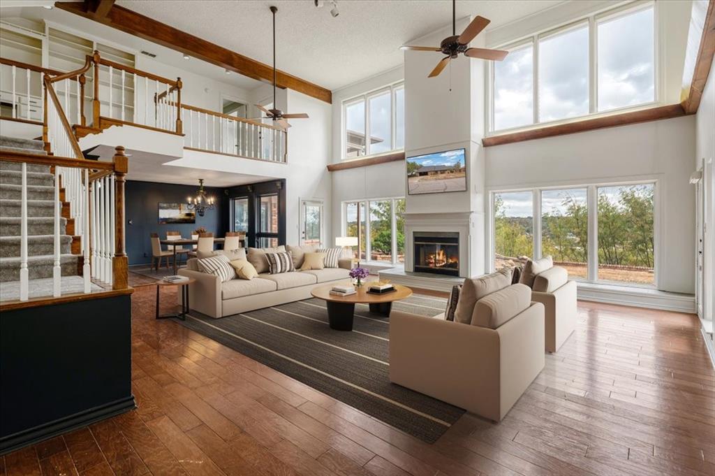 a living room with furniture fireplace and a large window