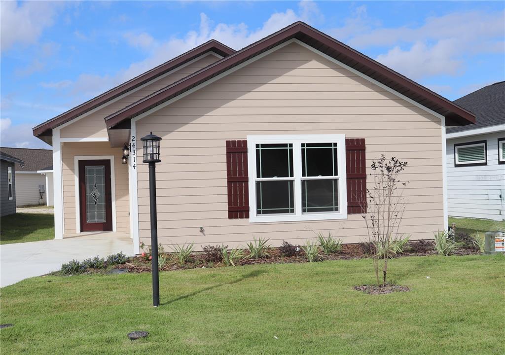 a front view of a house with a yard