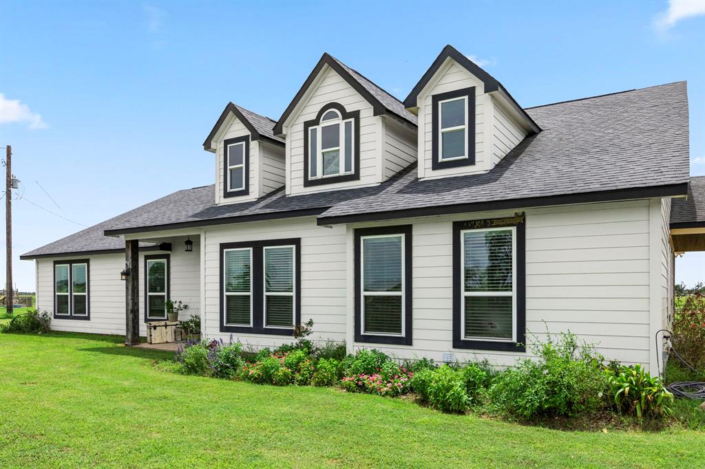 a front view of a house with a garden