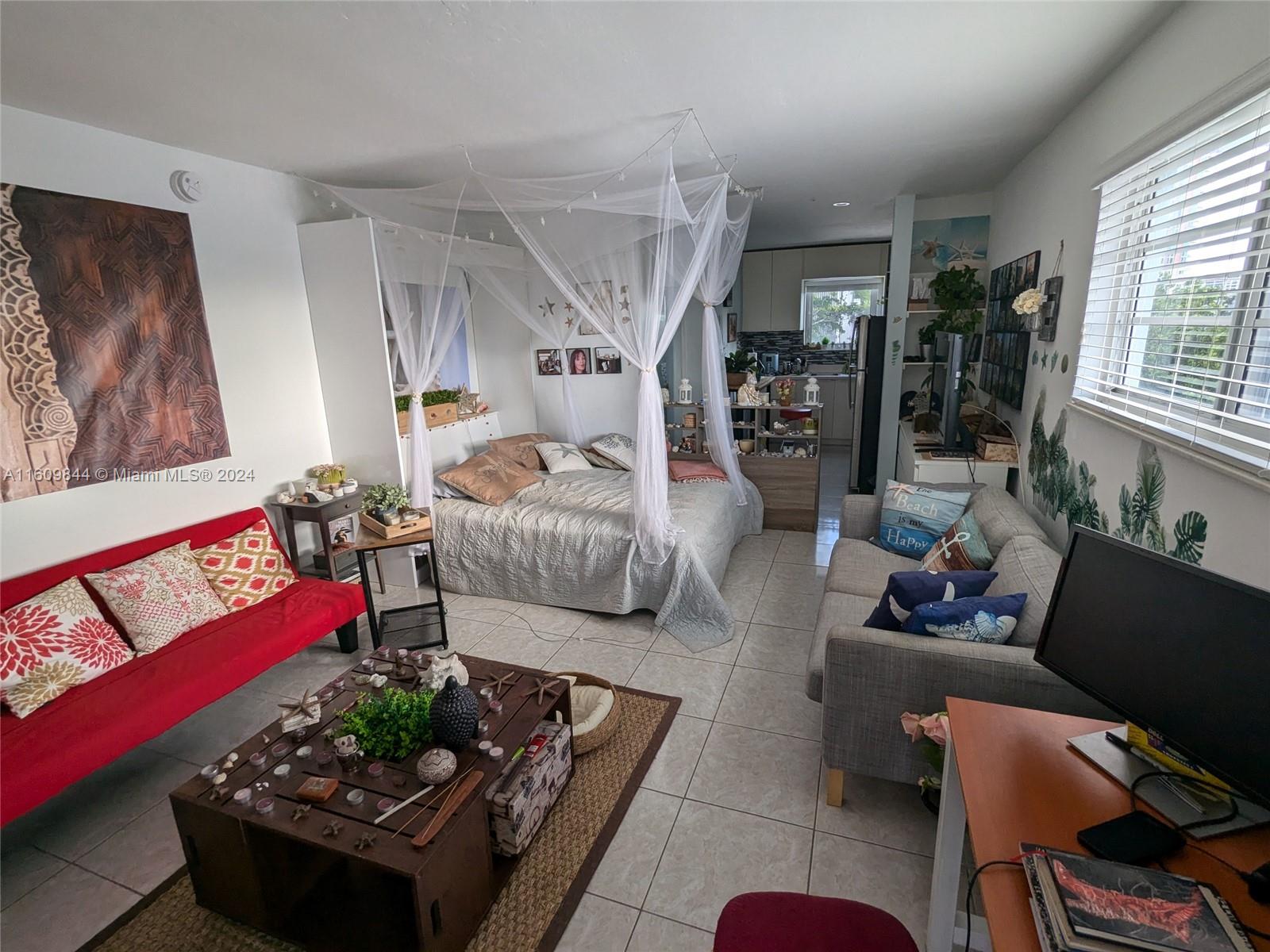 a living room with furniture rug and window