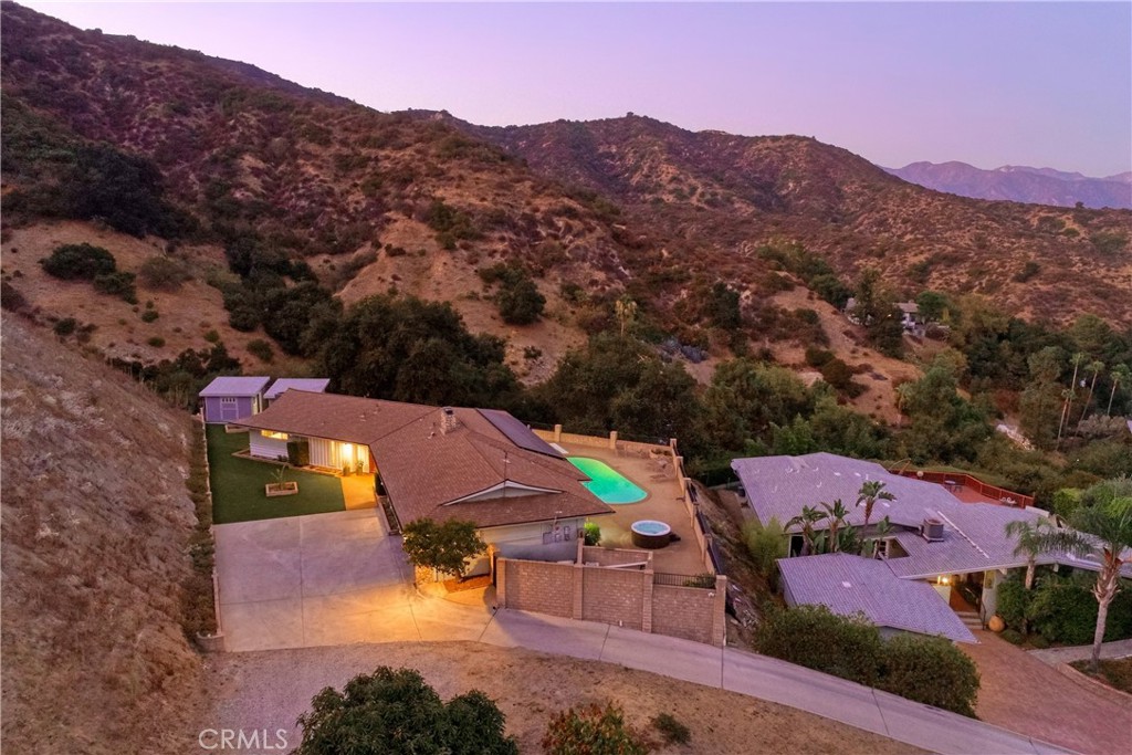 an aerial view of houses with a swimming pool