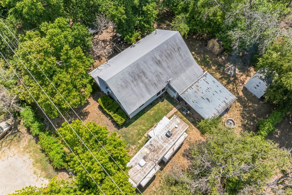 an aerial view of a house with garden space and sitting area