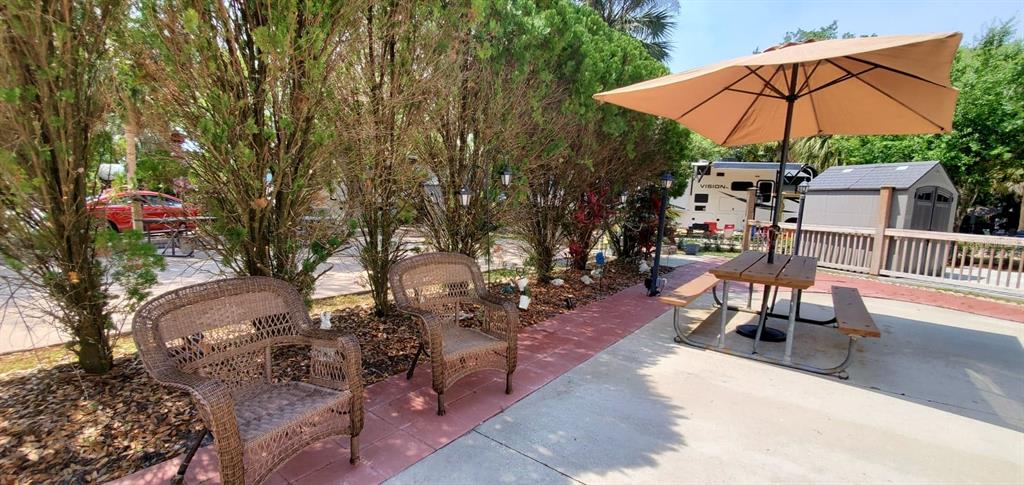 a view of a backyard with sitting area and furniture