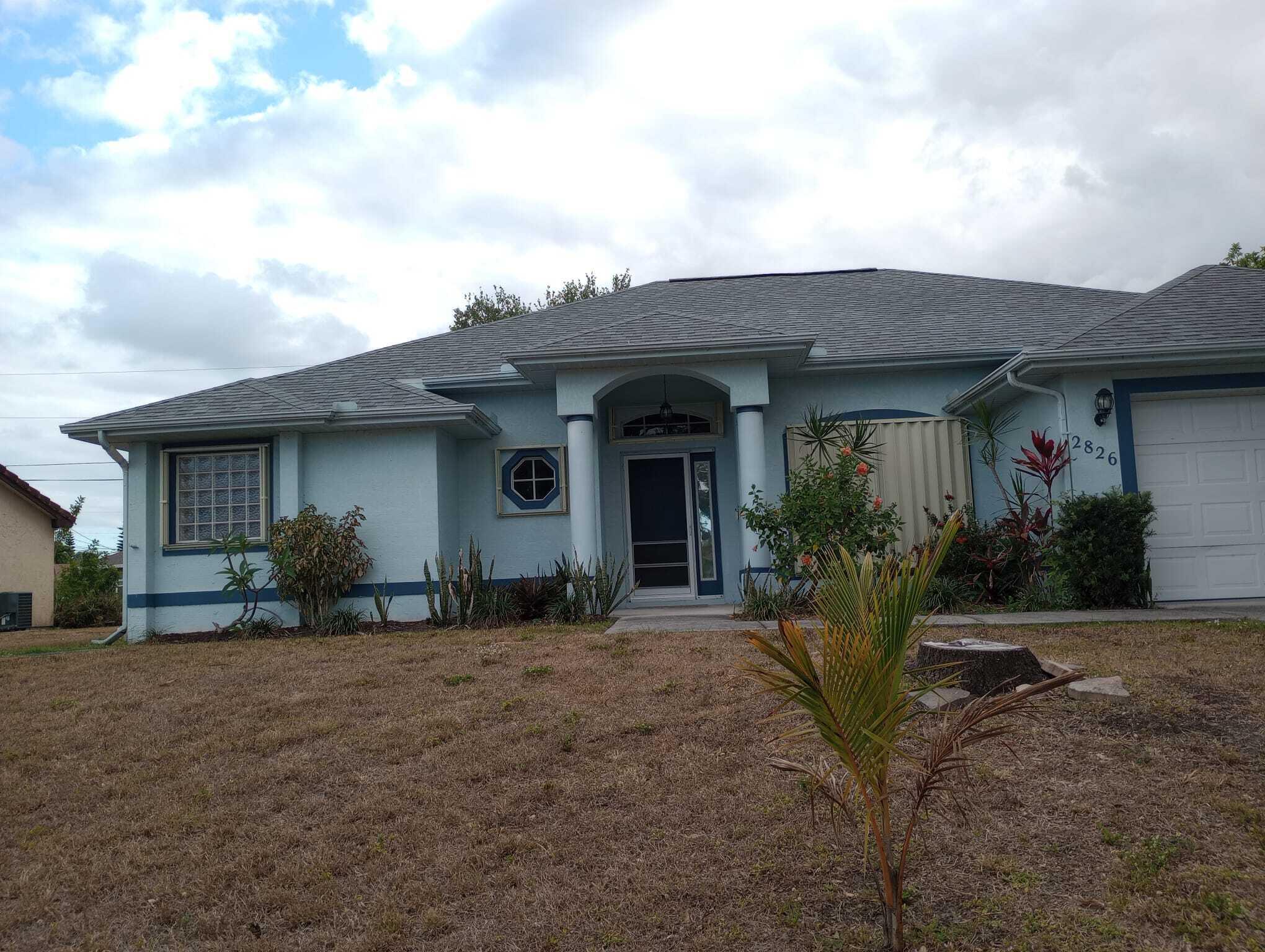 a front view of a house with yard outdoor seating and barbeque oven