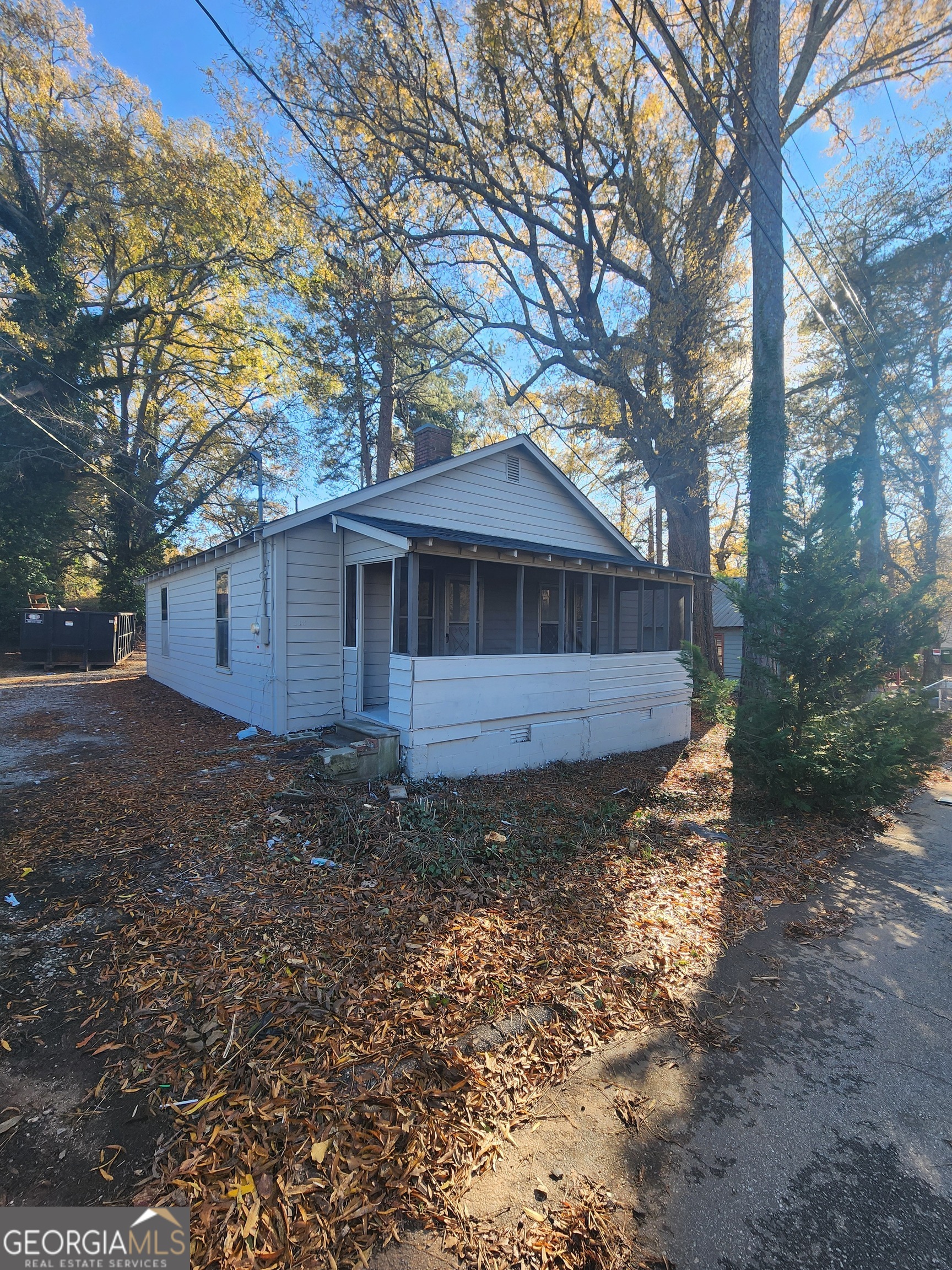 a view of a house with a yard and tree s