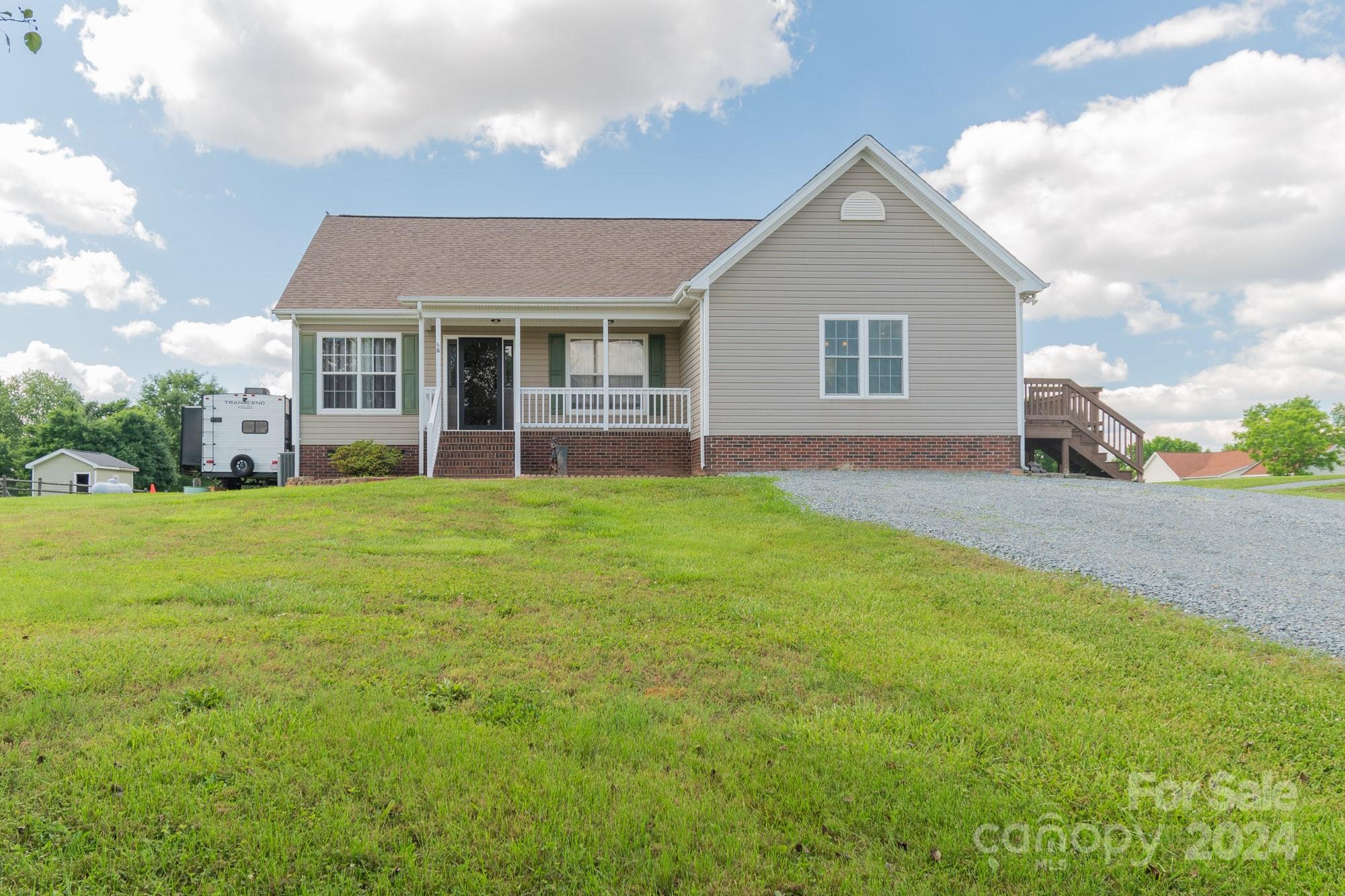 a front view of house with yard and green space