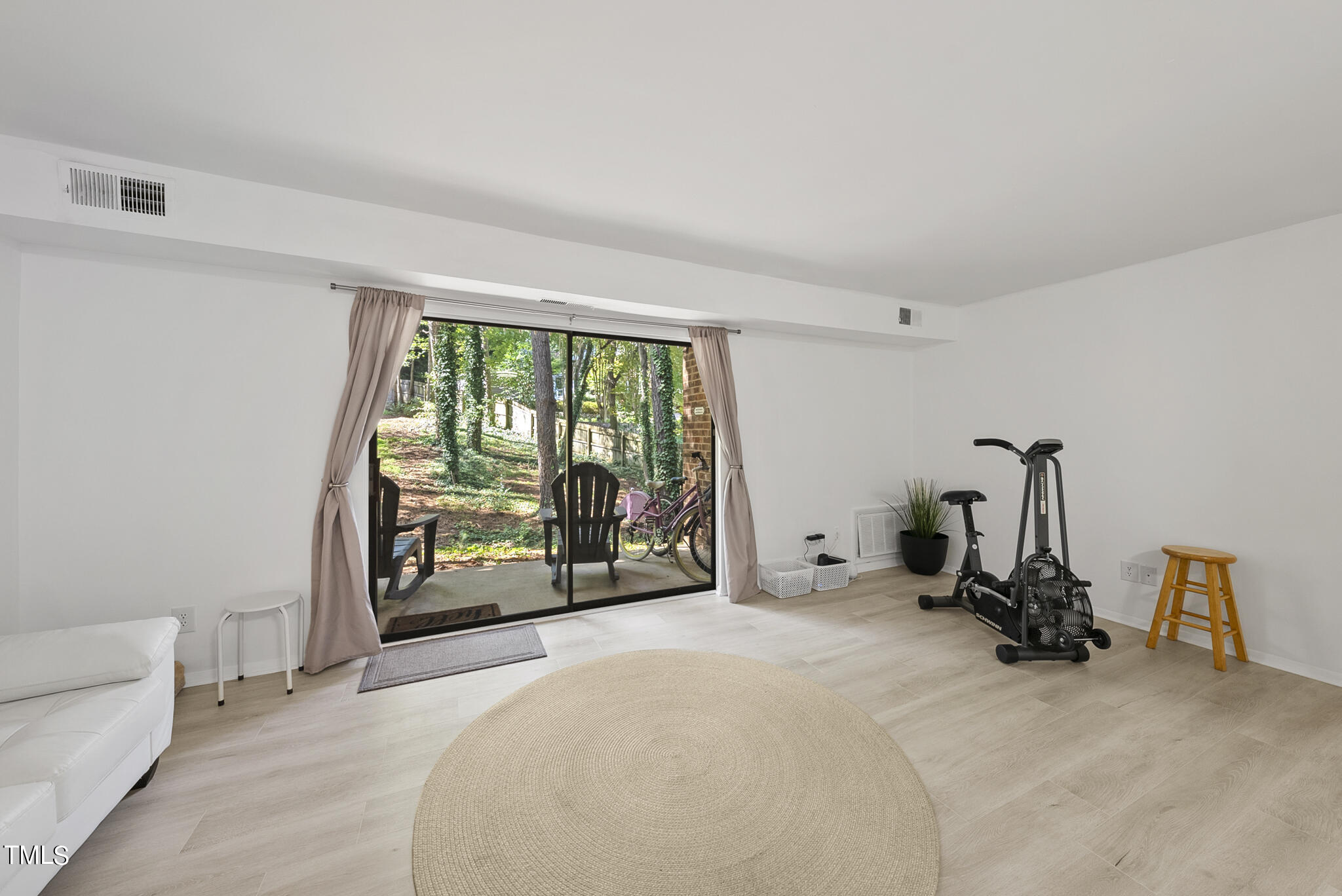 a view of a room with gym equipment and a large window