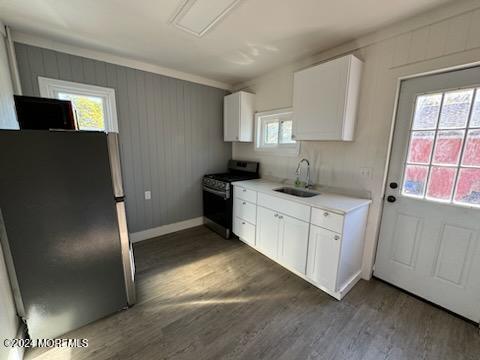 a kitchen with a refrigerator sink and cabinets