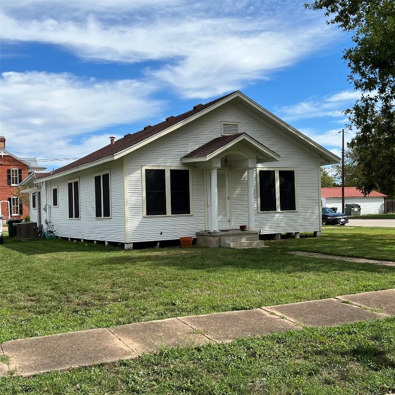 a front view of a house with a garden