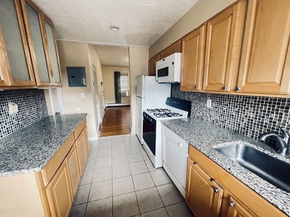 a kitchen with stainless steel appliances granite countertop a sink stove and cabinets