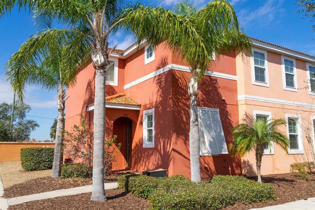 front view of a house with a palm tree