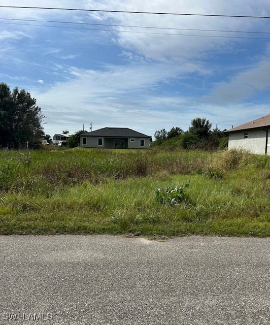 a view of a field with an ocean view