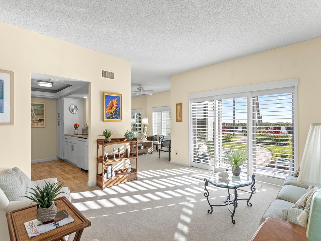 a living room with furniture and large windows