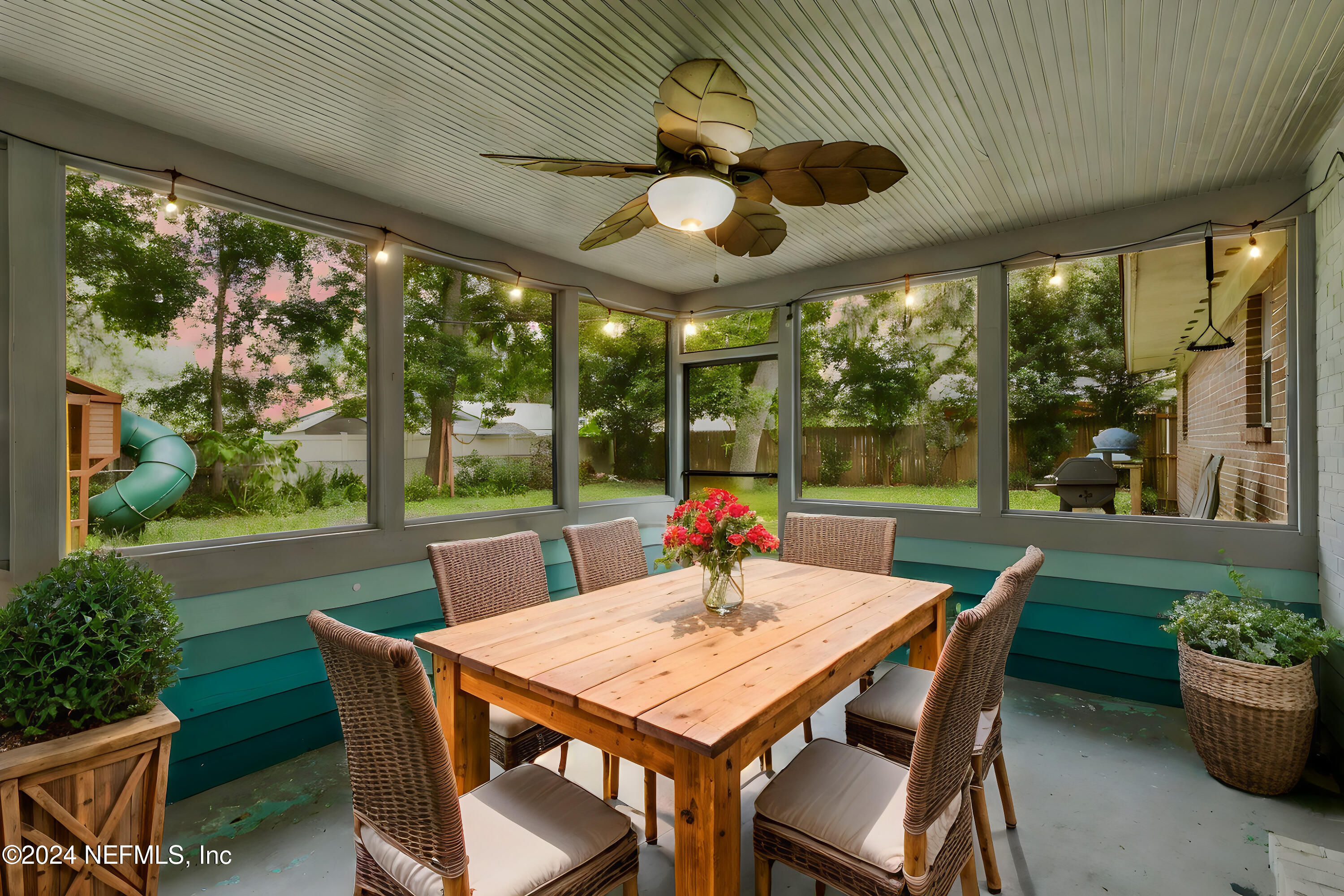 a view of an outdoor dining space with a table and chairs