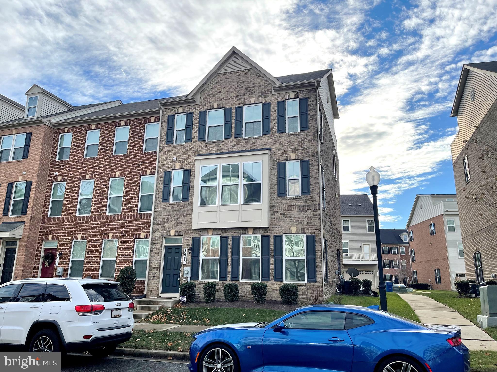 a car parked in front of a brick building