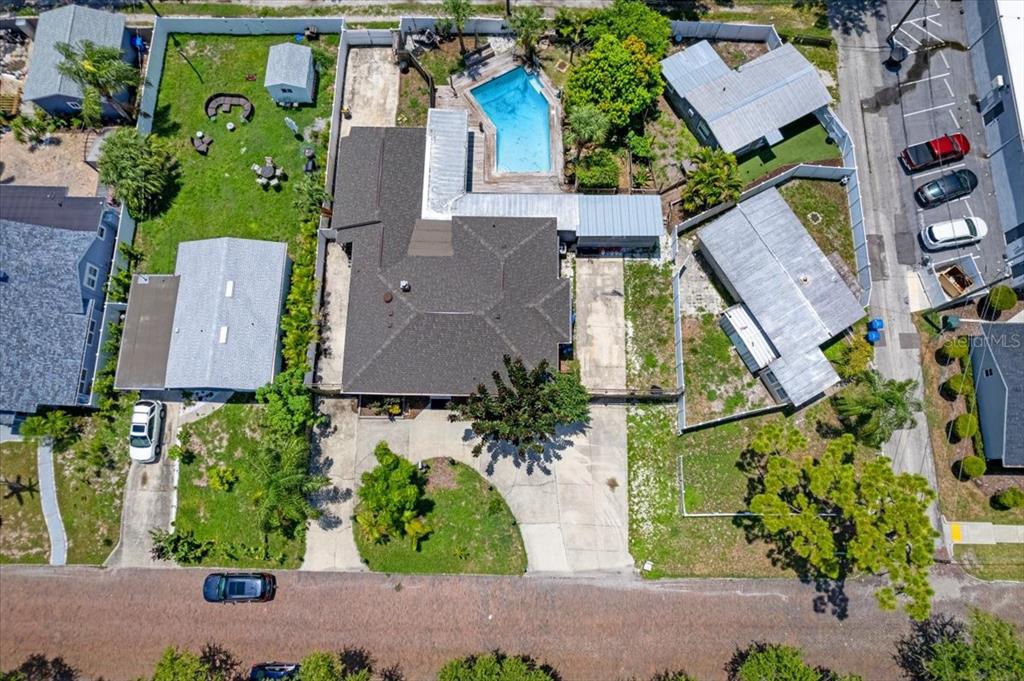 an aerial view of multiple houses with a yard