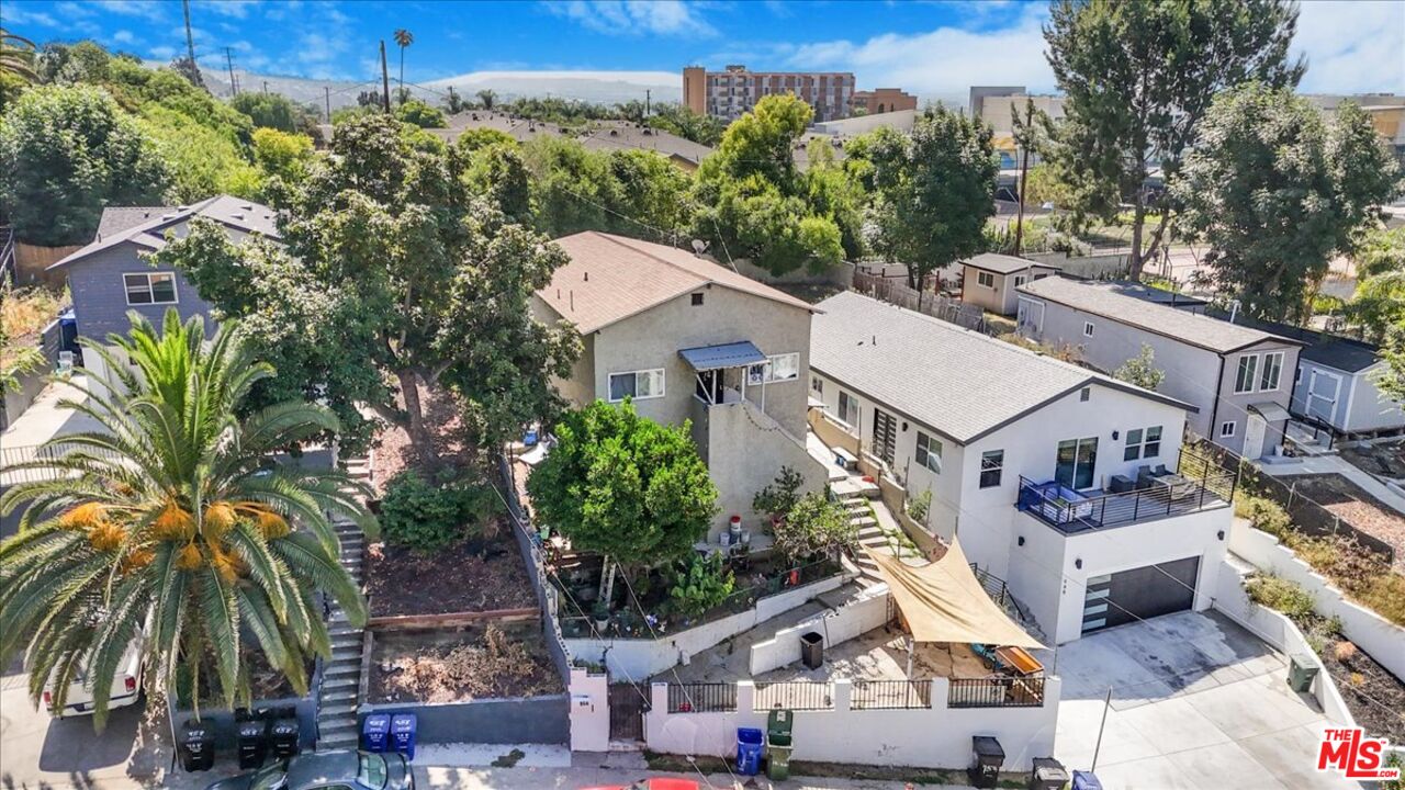 an aerial view of residential houses and car parked on street side