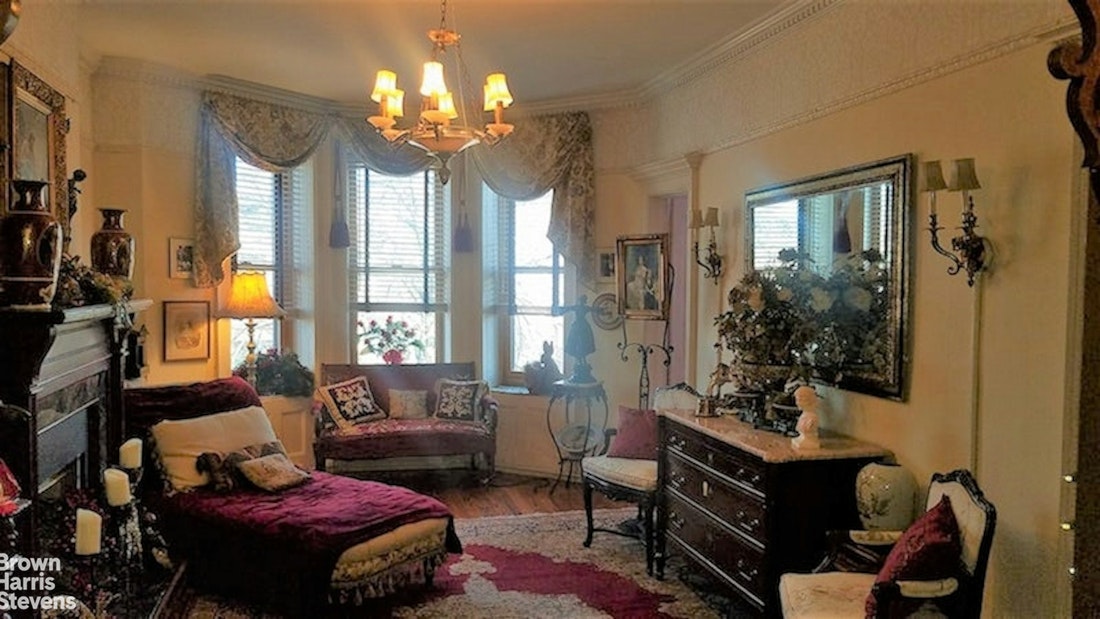 a living room with patio furniture and a chandelier