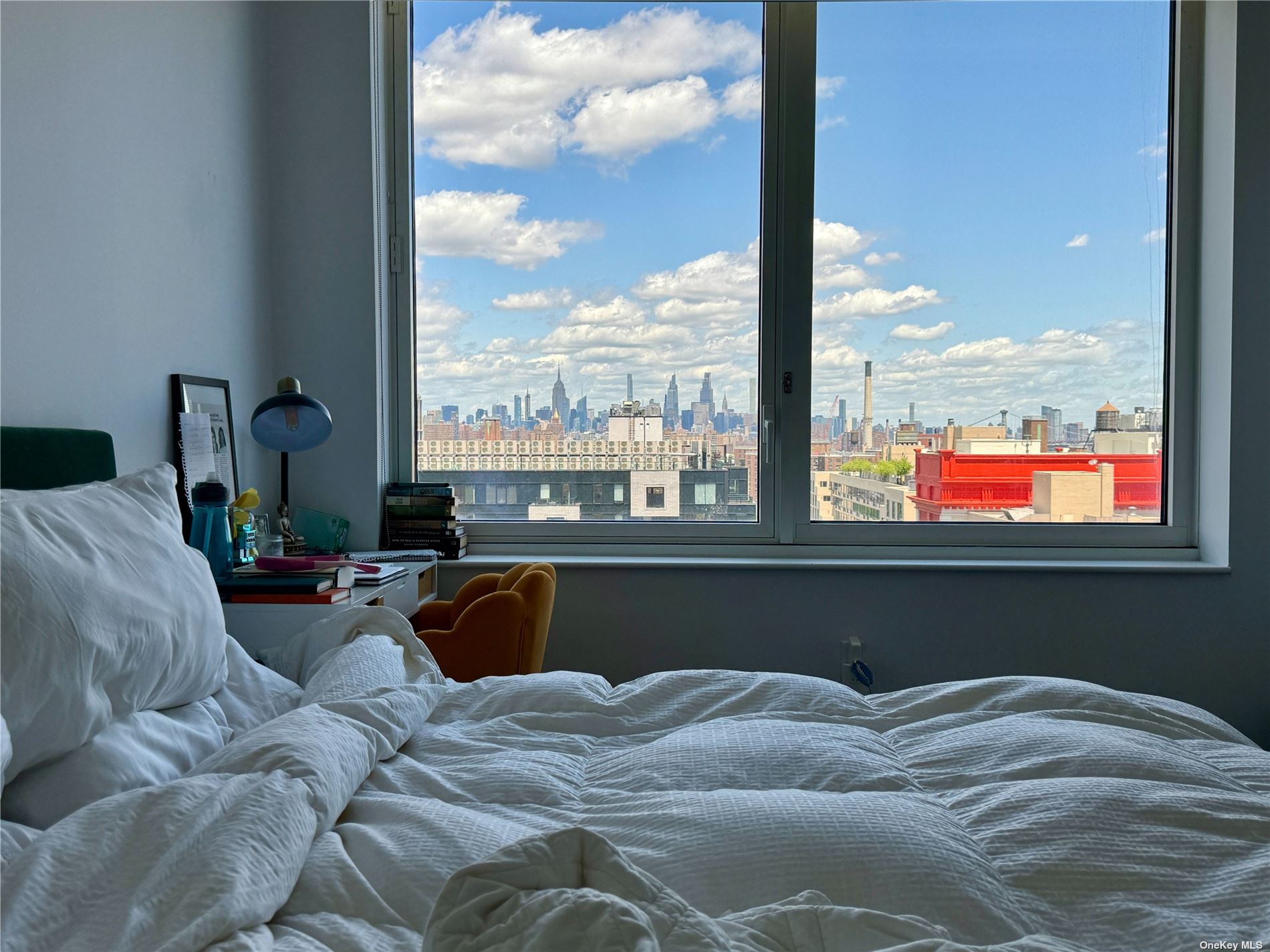 a bed sitting in a bedroom next to a window