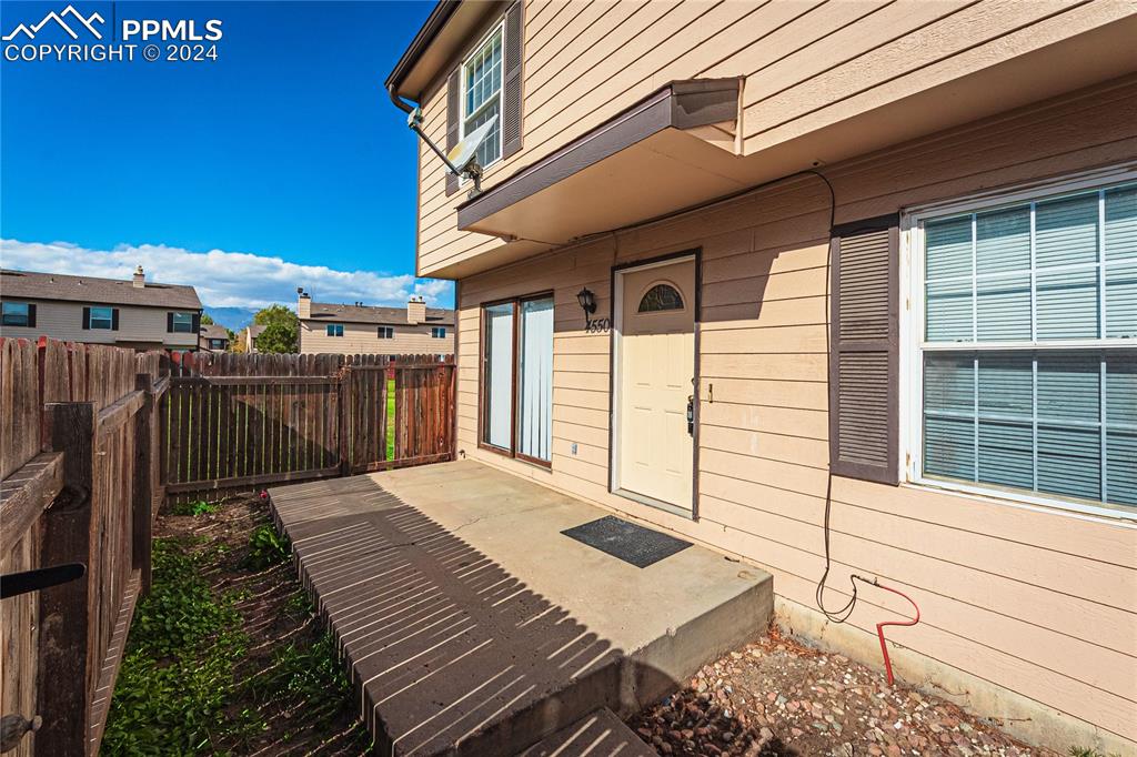 a view of a backyard with wooden fence