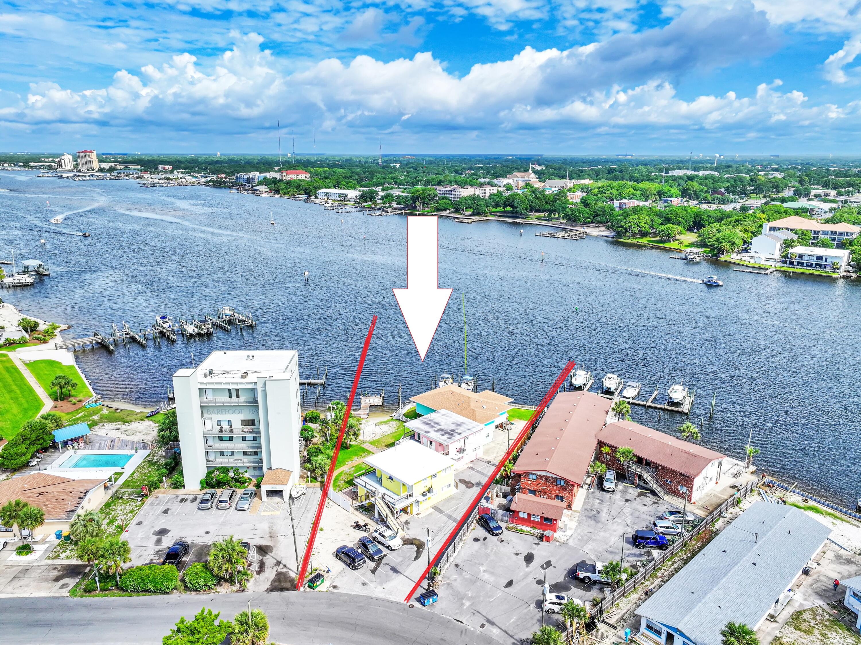 an aerial view of a house with a yard and lake view