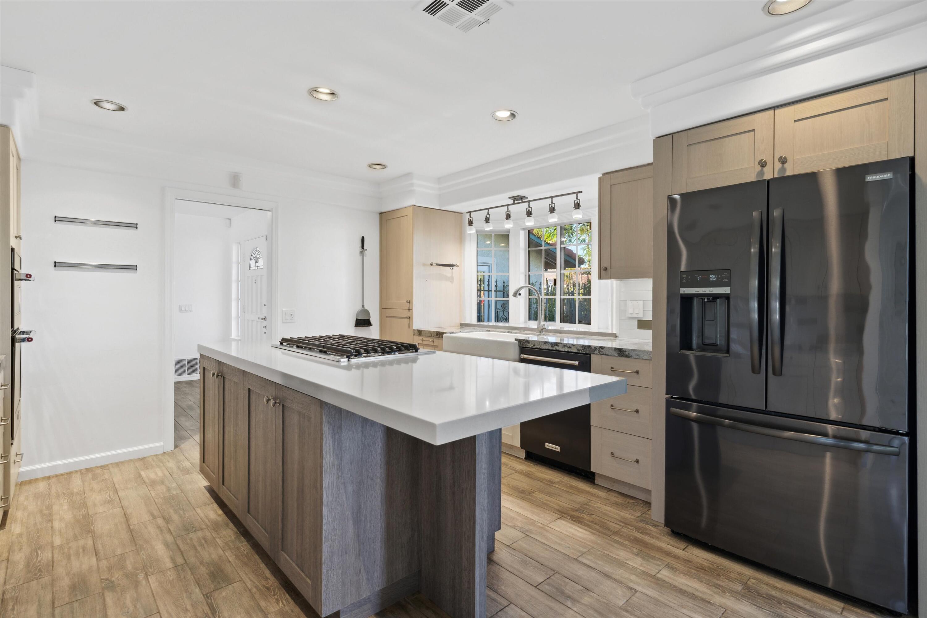 a kitchen with stainless steel appliances a sink stove and refrigerator