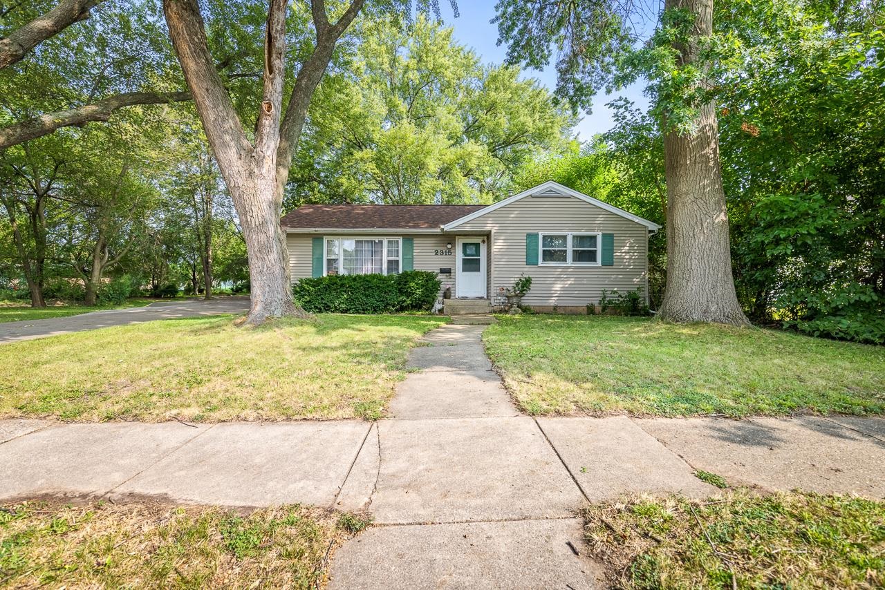 a front view of a house with yard