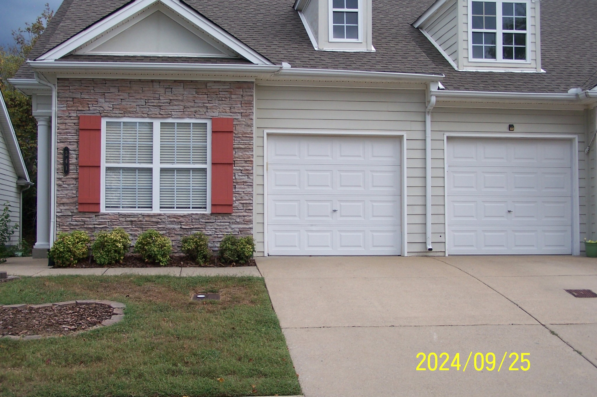 a front view of a house with a garden