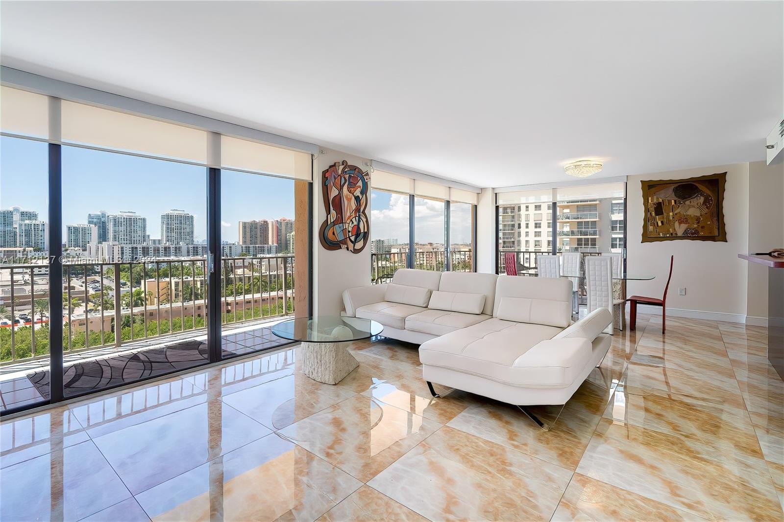 a living room with furniture and a floor to ceiling window