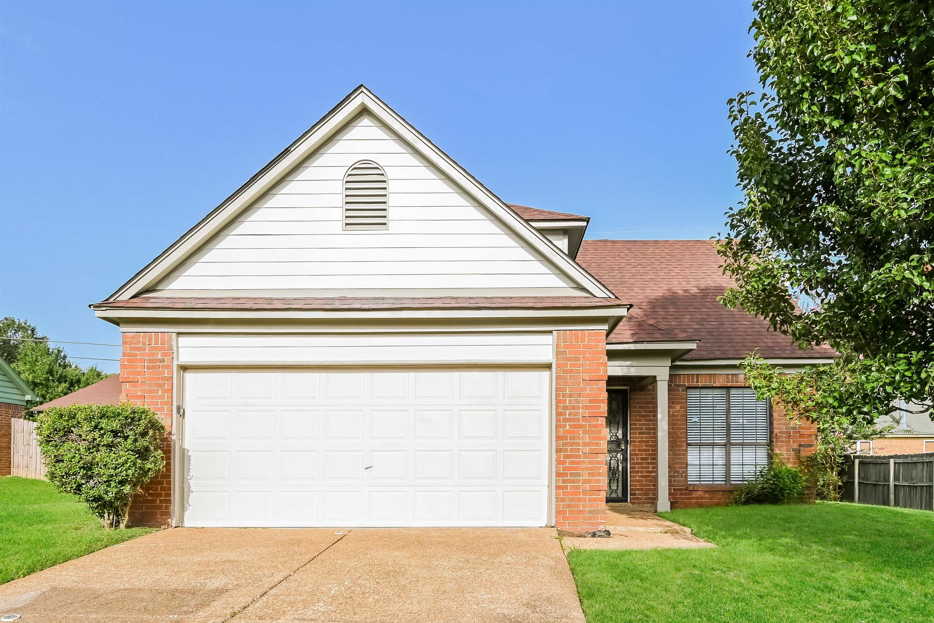 View of front facade with a garage and a front lawn