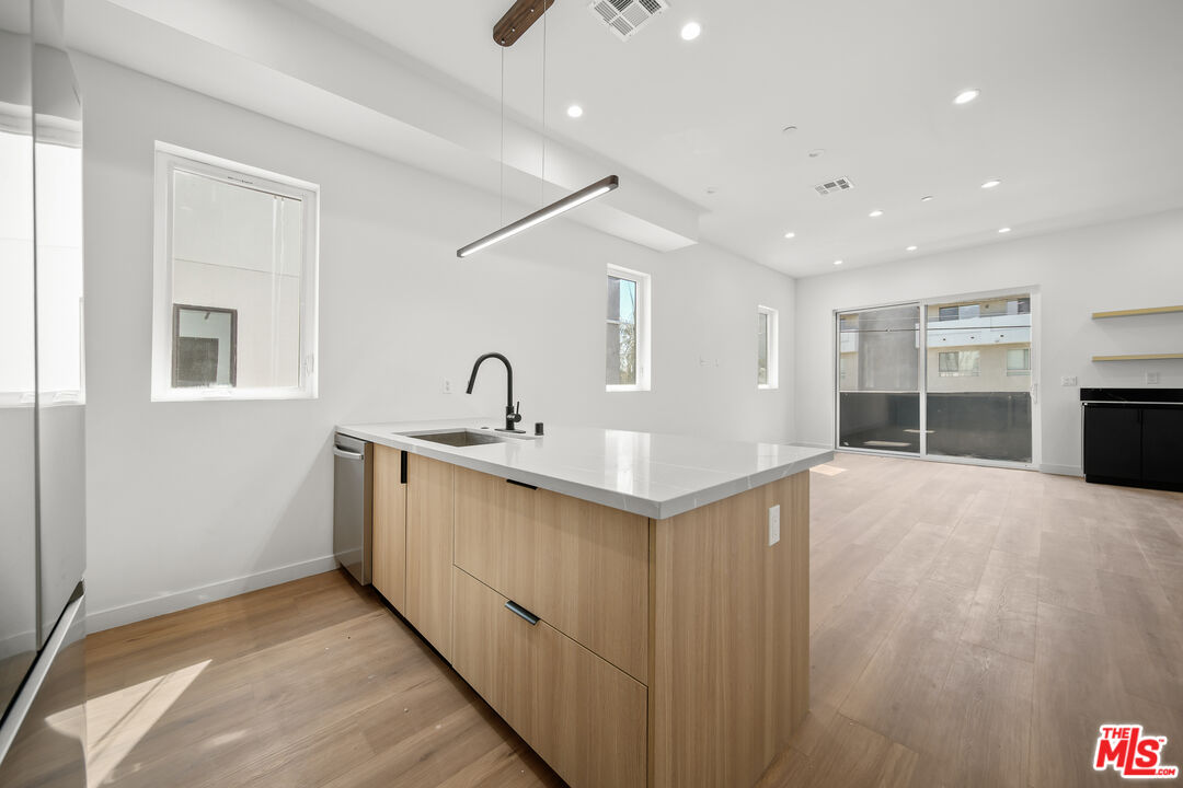 a view of a kitchen with a sink and dishwasher