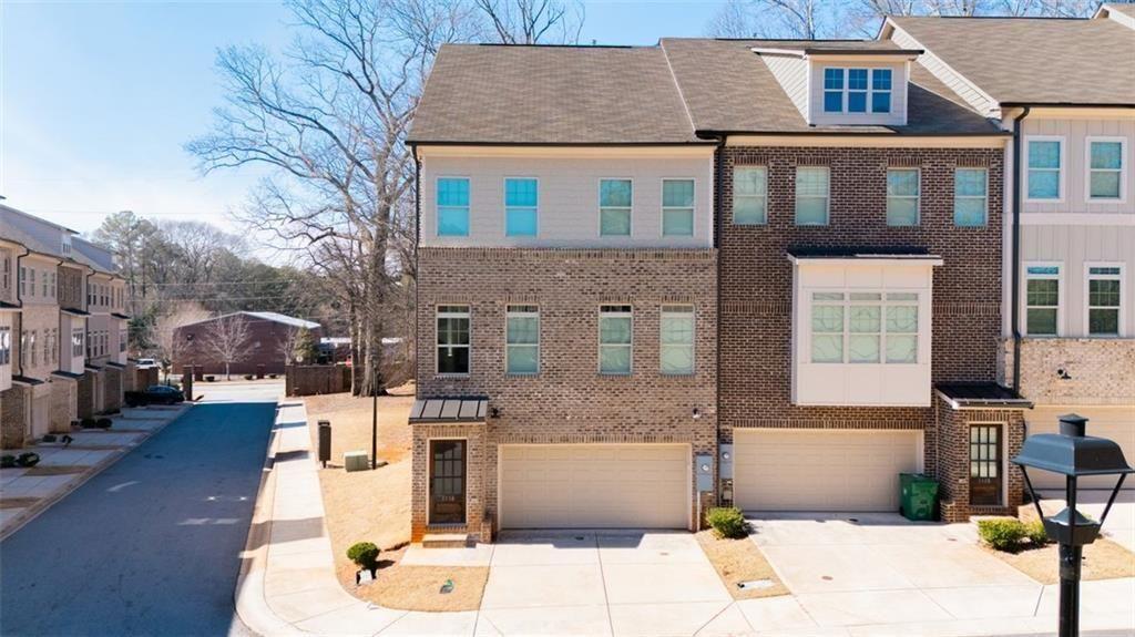 a front view of a residential apartment building with a yard