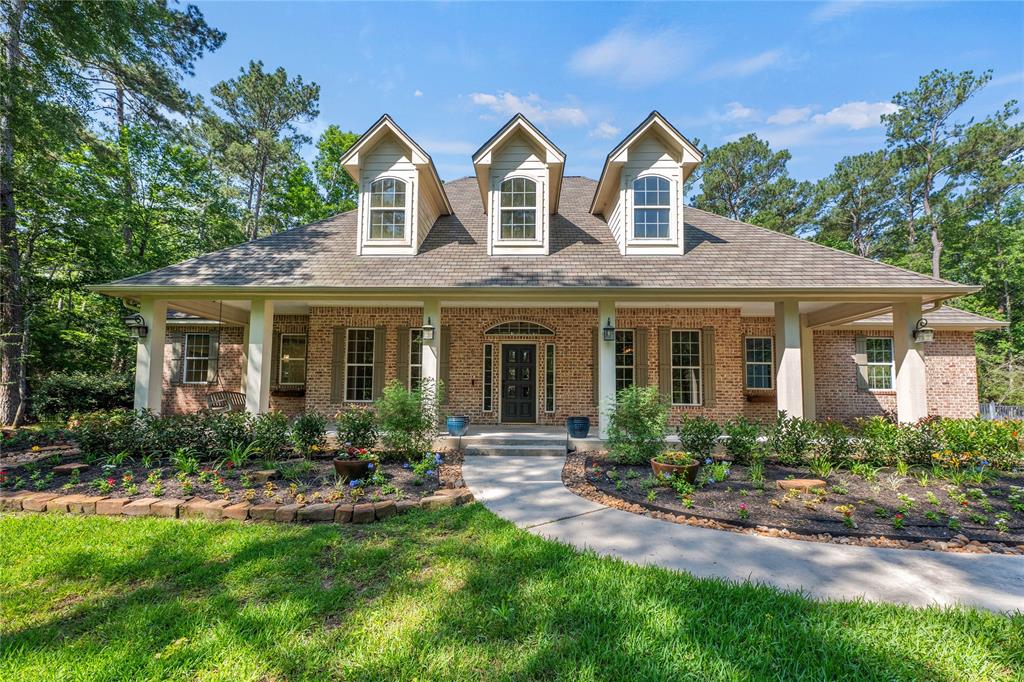 a front view of a house with yard porch and furniture