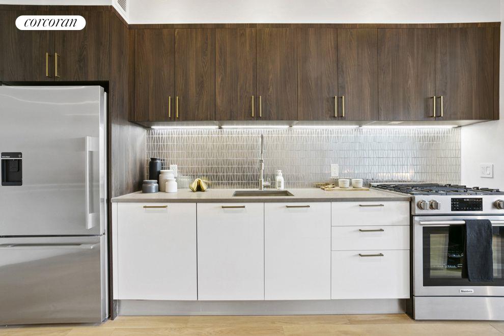 a kitchen with stainless steel appliances granite countertop a refrigerator sink and cabinets