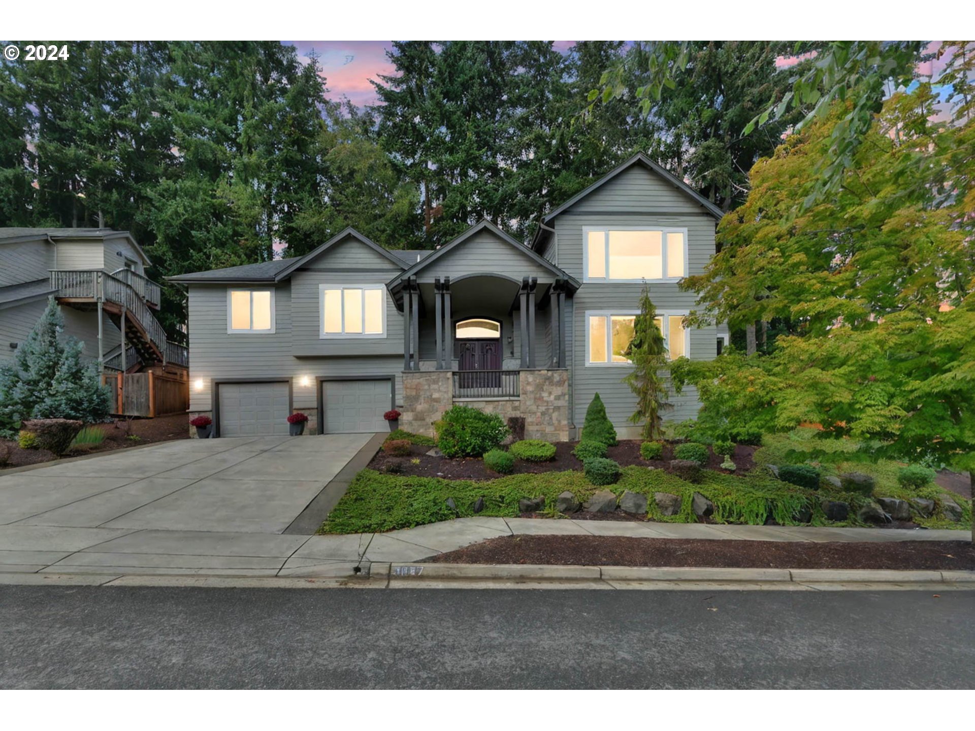 a front view of a house with a yard and garage