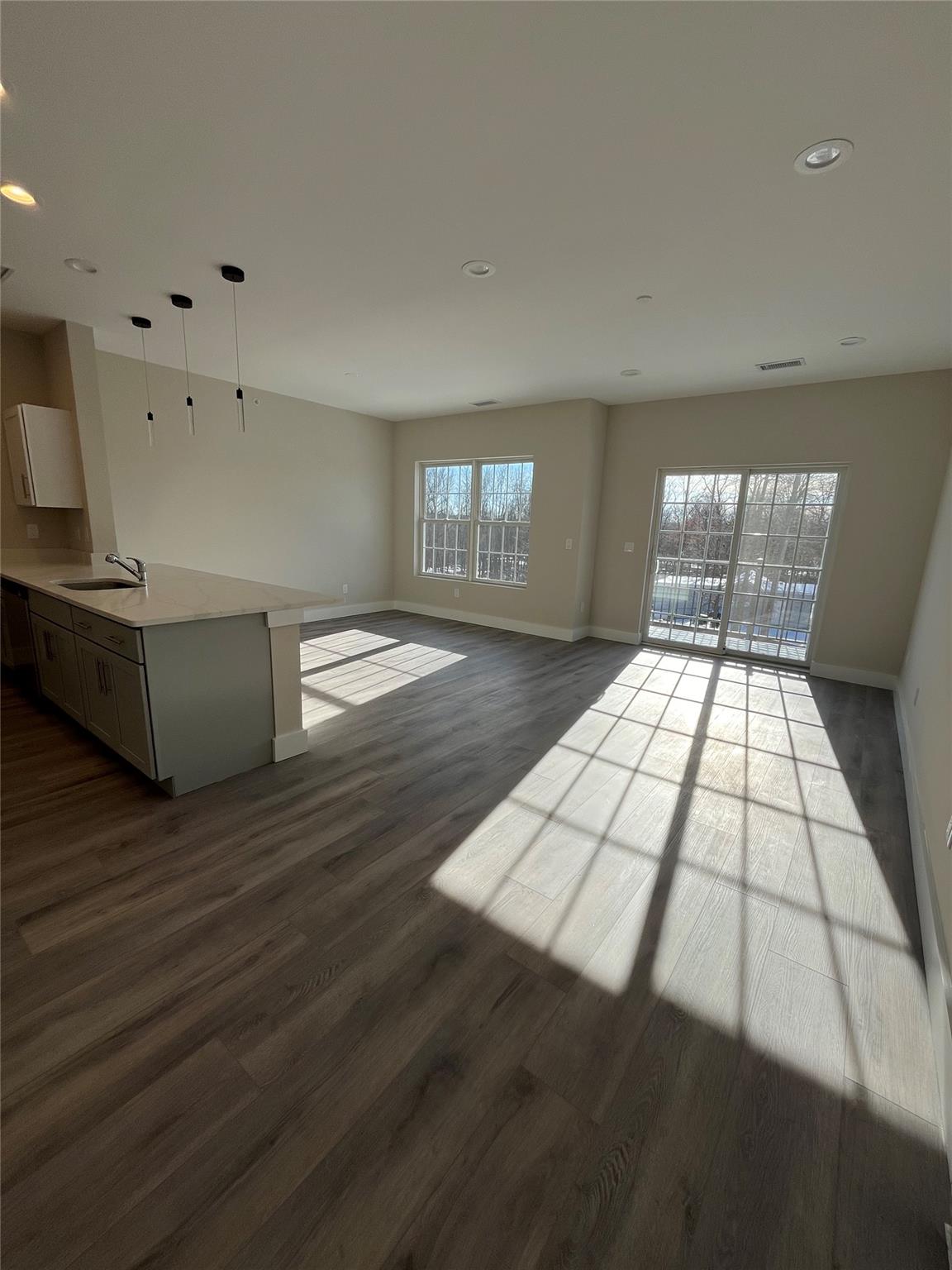 a living room with hard wood floors and a fireplace