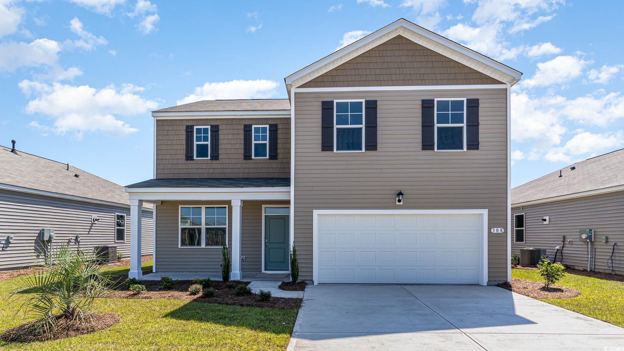 View of front property featuring a garage, a front