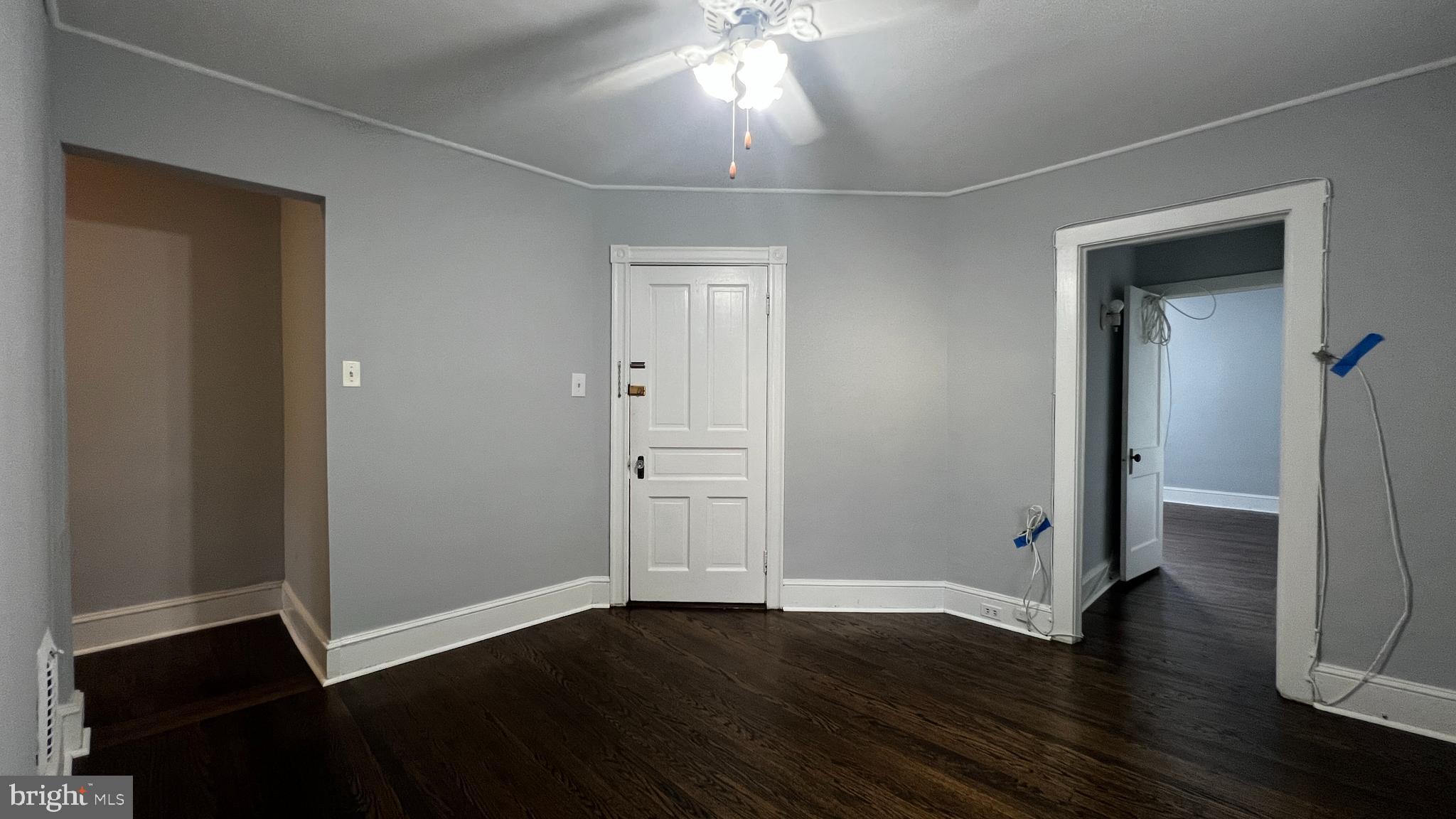 an empty room with wooden floor and closet