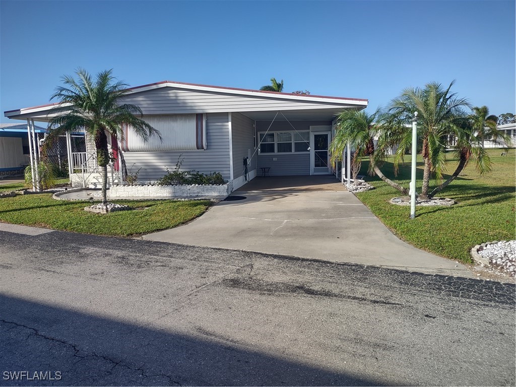 a front view of house with yard and green space