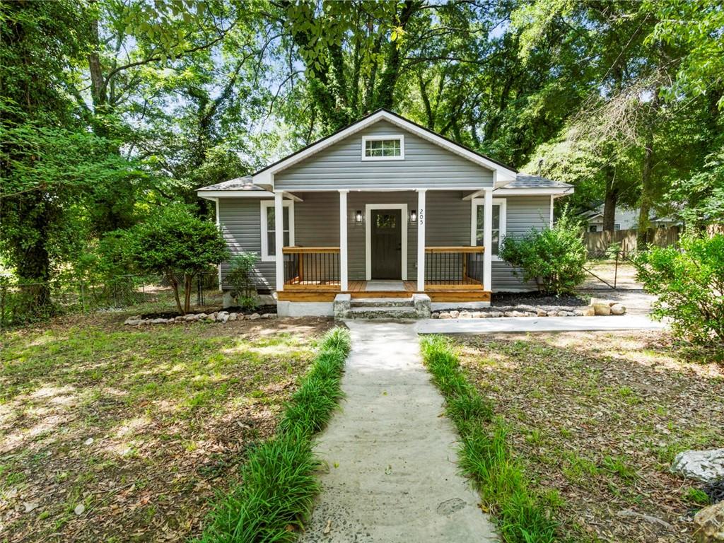 a front view of a house with yard patio and green space