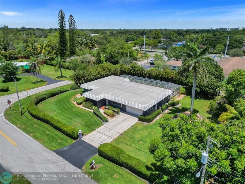 an aerial view of a house with a yard