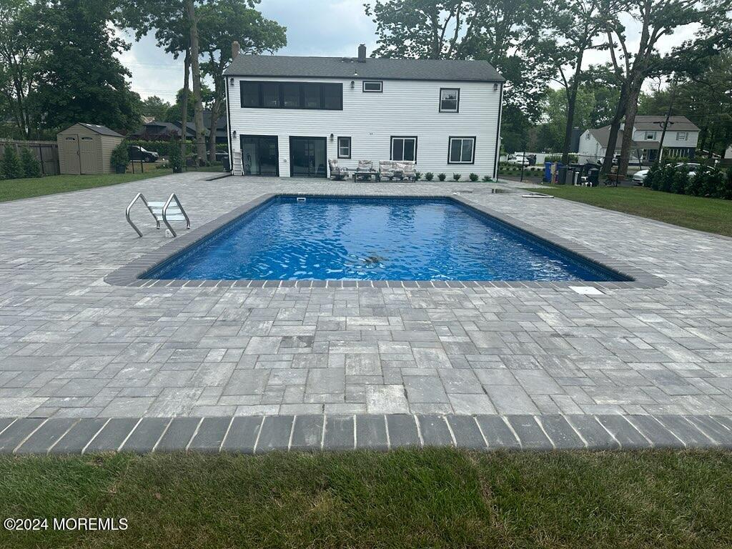 a view of a house with backyard patio and fire pit