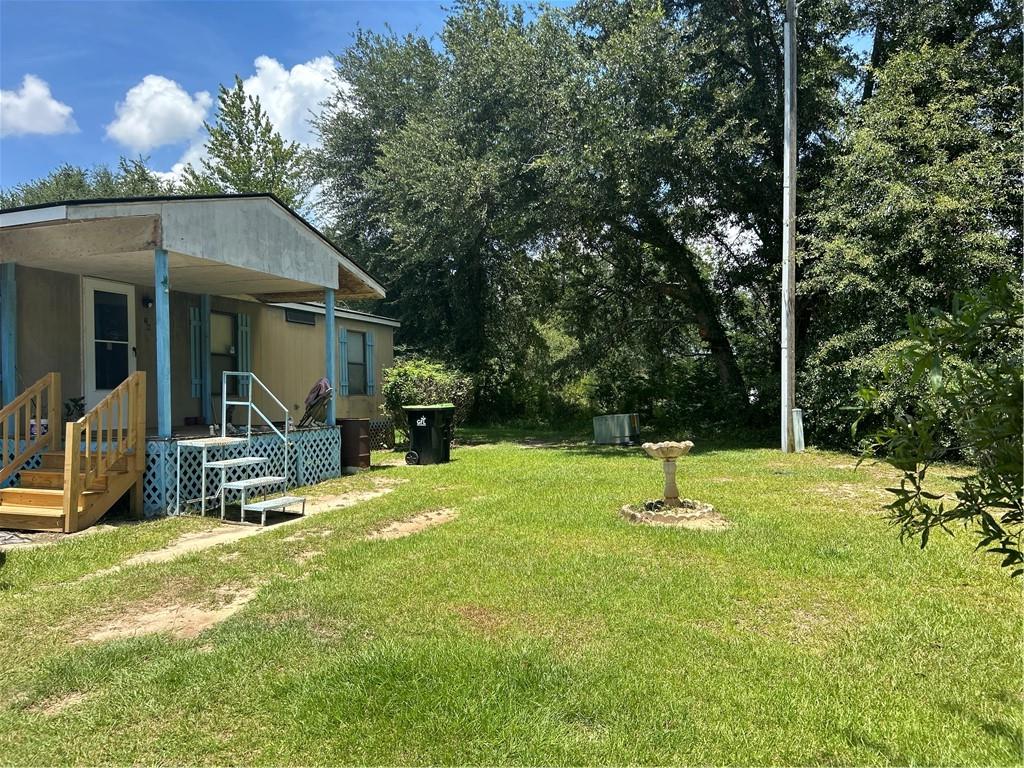 a backyard of a house with table and chairs